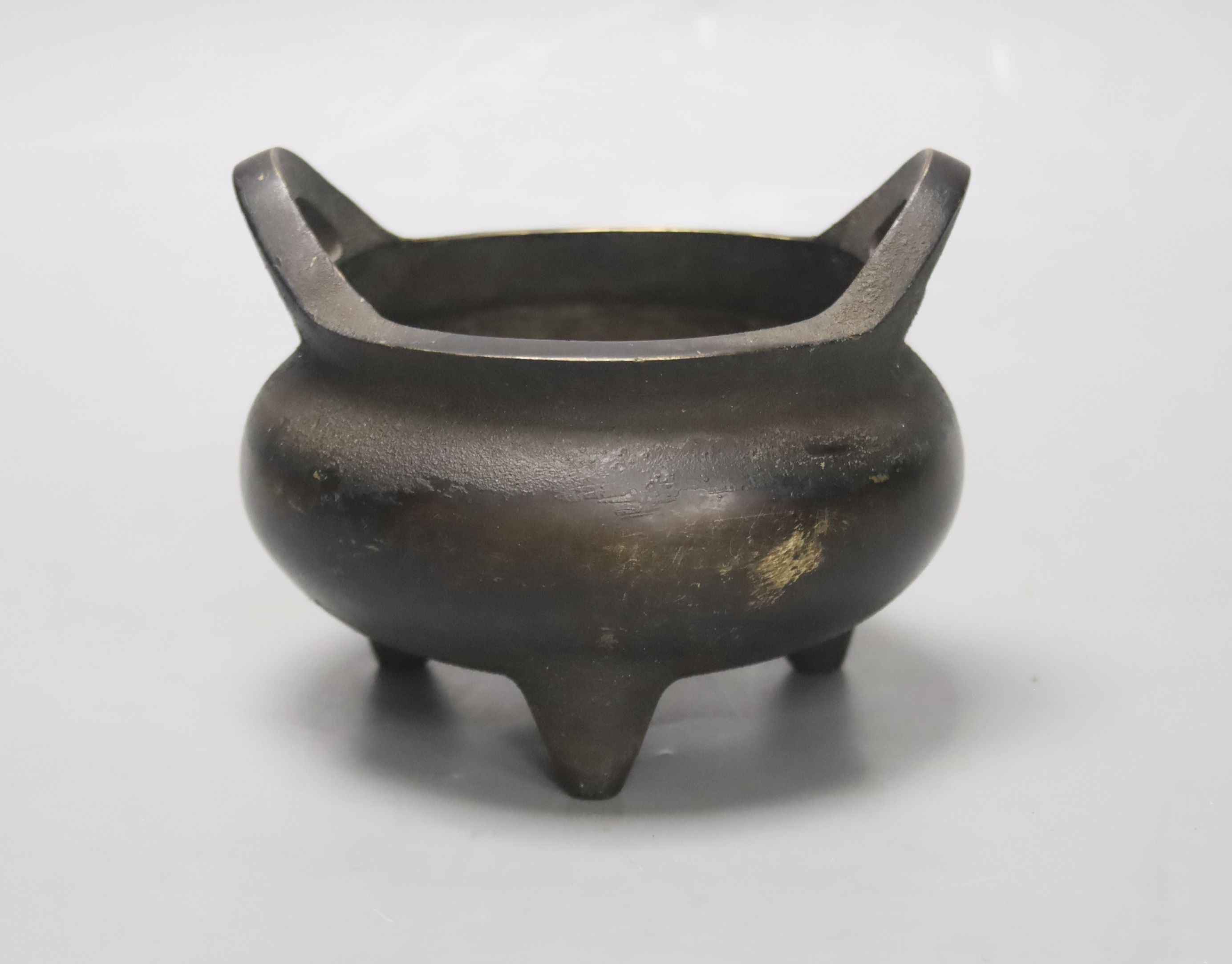 A Chinese bronze tripod censer, Xuande four character mark height 10cm